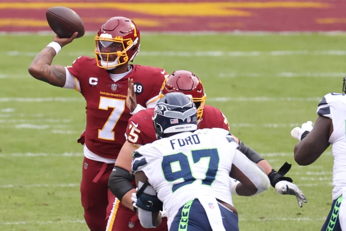 Washington Football Team quarterback Dwayne Haskins Jr. (7) passes the ball as Seattle Seahawks defensive tackle Poona Ford (97) defends in the second quarter at FedExField. The back of Ford's helmet reads, "Breonna Taylor." © Geoff Burke-USA TODAY Sports